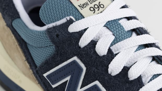 Detailed look at a blue and white New Balance shoe.